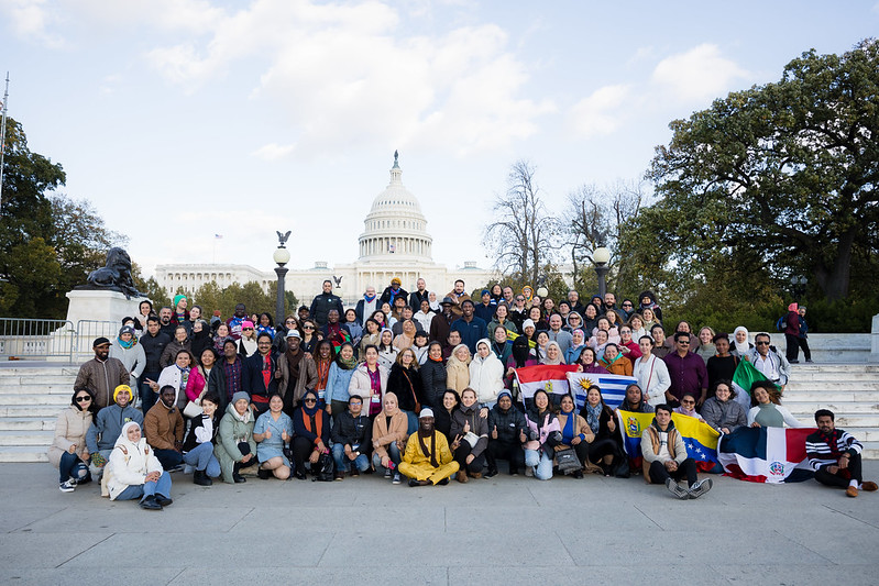 A group of people posing outside of the U.S. Capitol