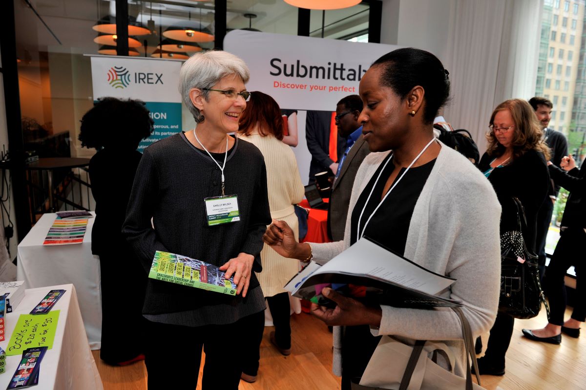 A group of women at the Impact Fellowships Summit conversing. 