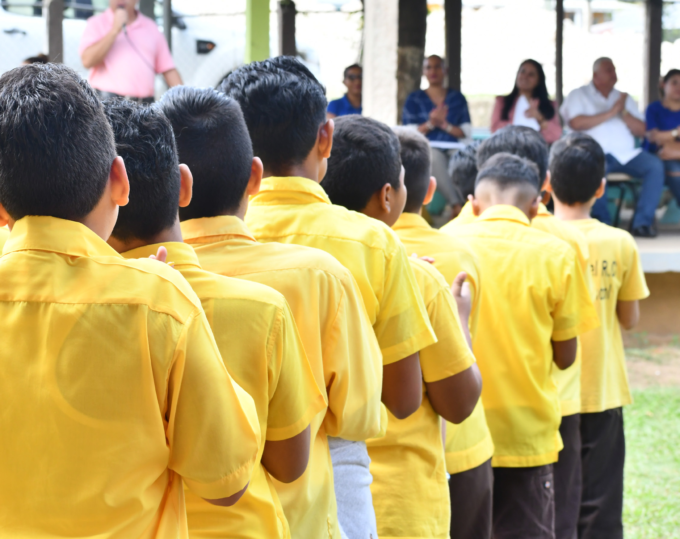 Image of the back view  school children in Belize lined up. 