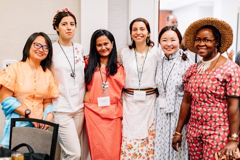 Group of middle aged women of various nationalities standing together for a picture