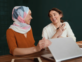 image of two females smiling at each other 