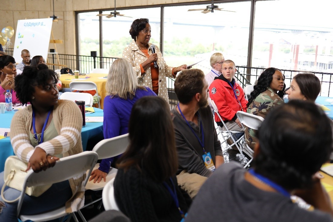 A person speaking to a group of people